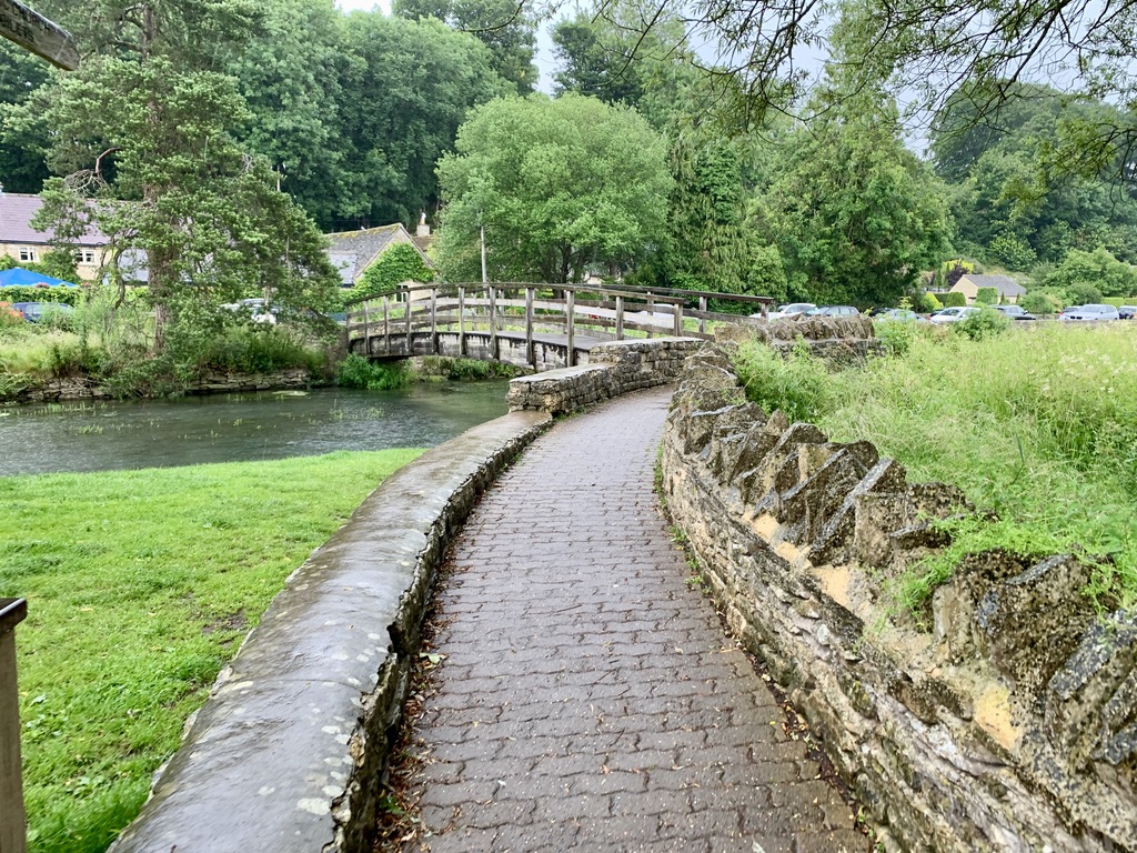 A bridge runs over the river in Bibury, Cotswolds, England