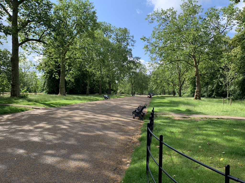 Photos of London: paved path in Hyde Park with benches lining the path.