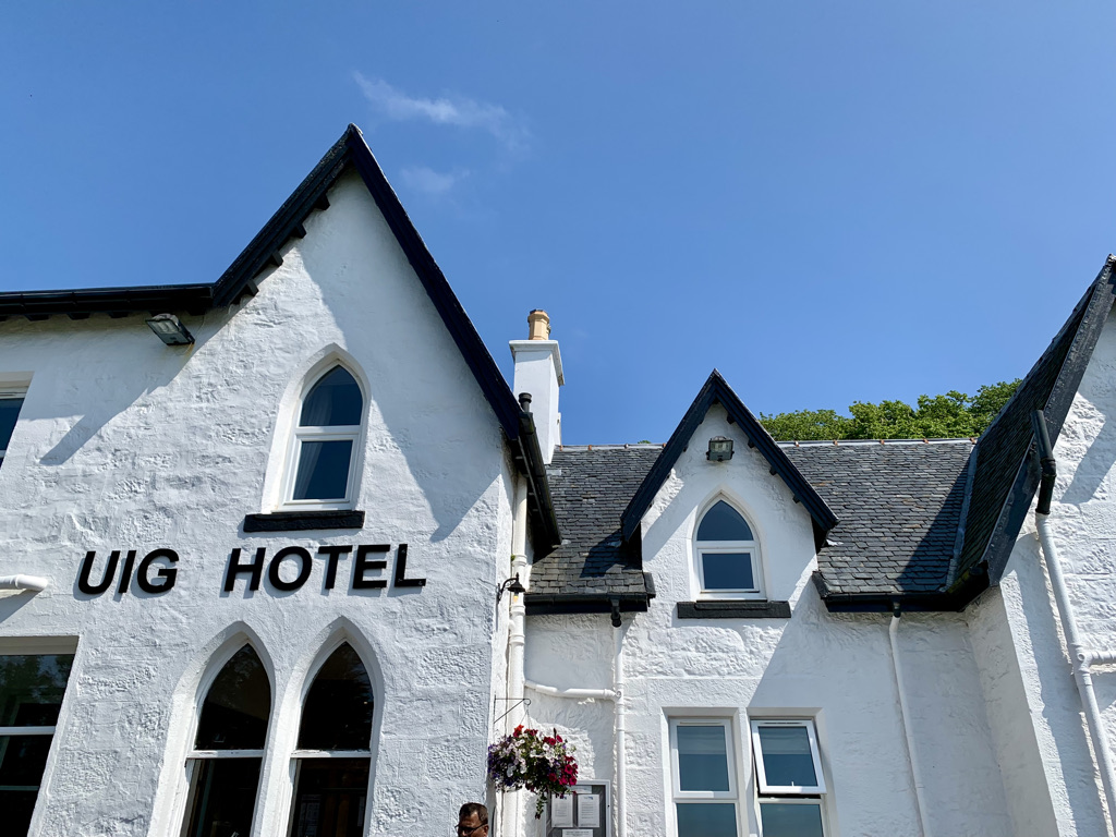 The Uig Hotel is a classic whitewashed Scottish hotel, and looks out over a scenic view of the water.