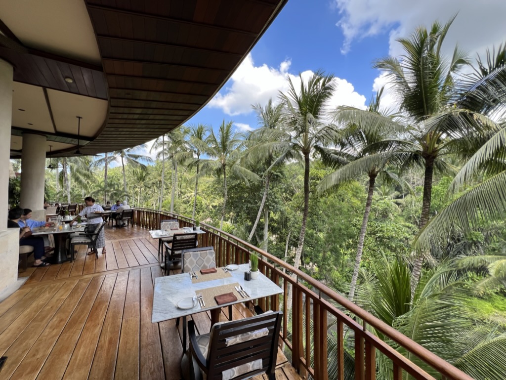 Open terrace restaurant with views of palm trees and the Ayung River in Sayan, Bali