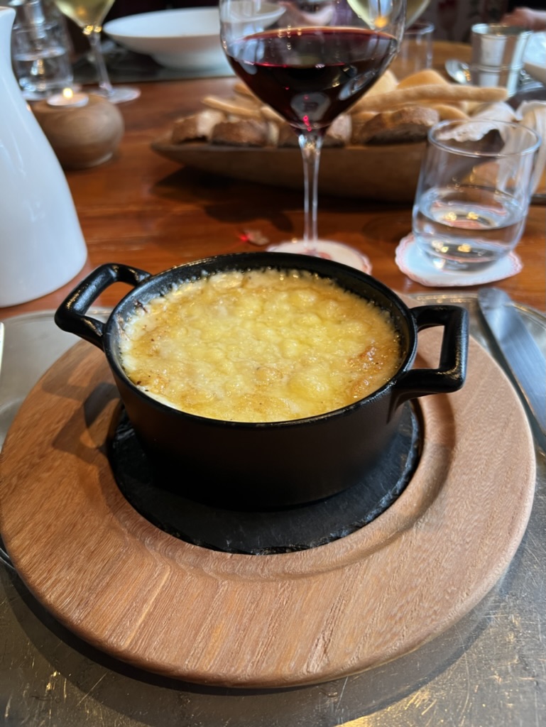 Bubbling cheese fondue and a glass of red wine at the Bar à Fromage in Cogne, Italy