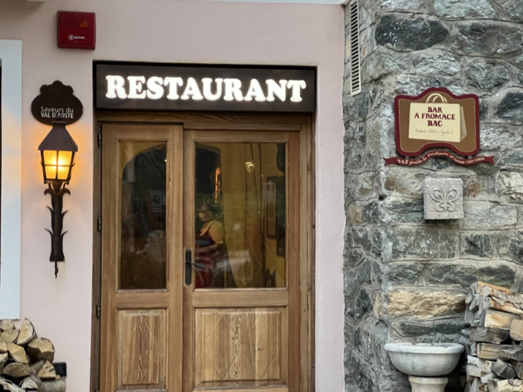 The wooden exterior door of the Bar à Fromage in Cogne Italy